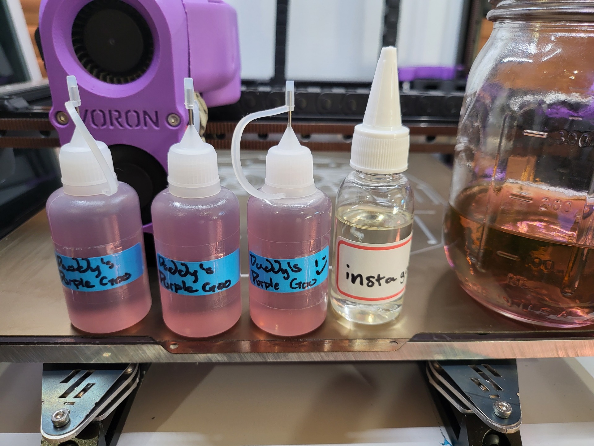 bottles of instagoo on the print bed of Voron V2.1112